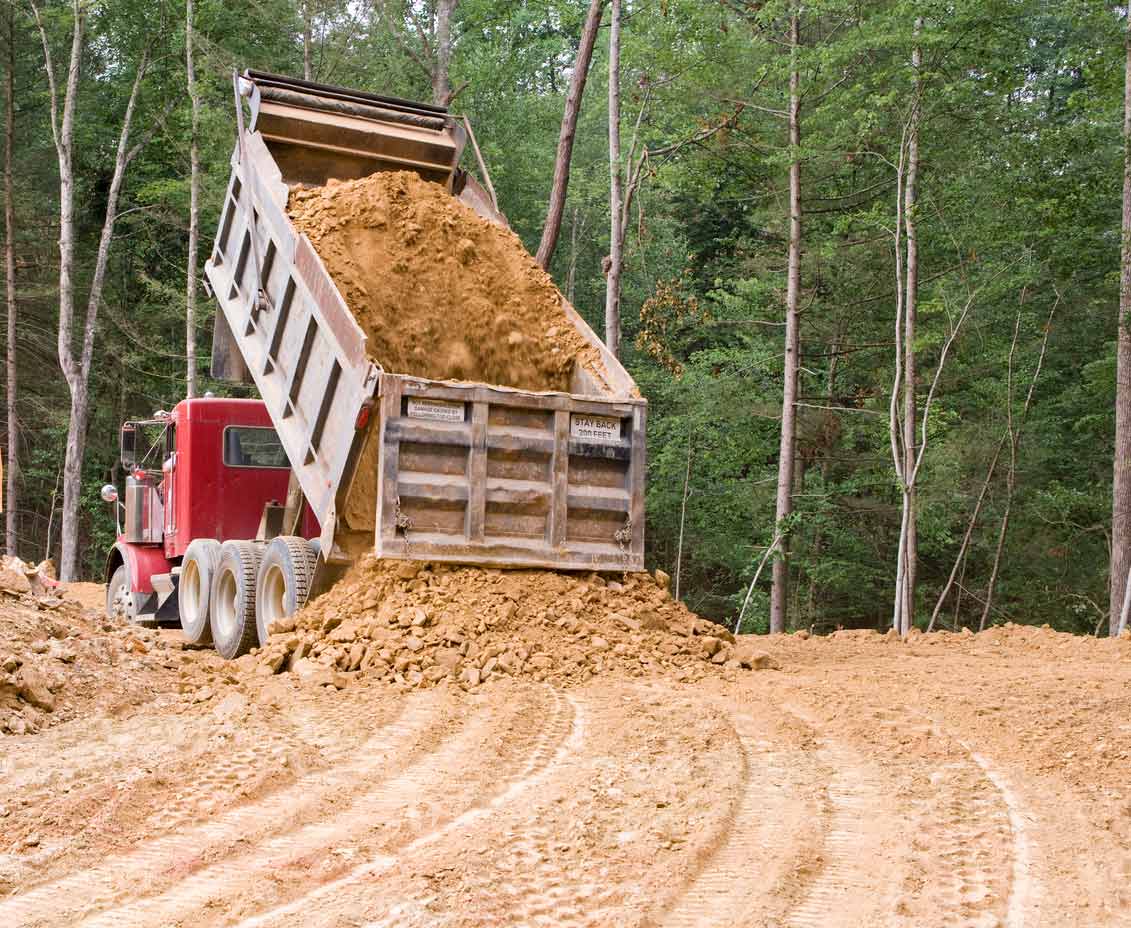 Dump truck unloading fill dirt