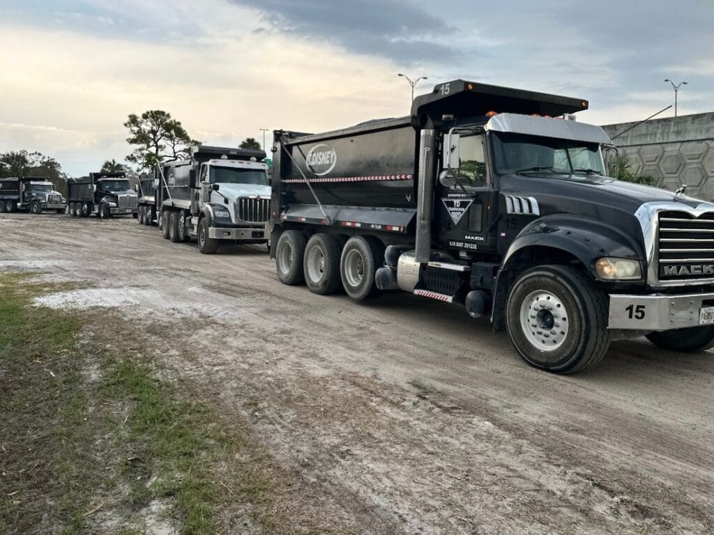 T. Disney Trucking dump trucks lined up at the yard